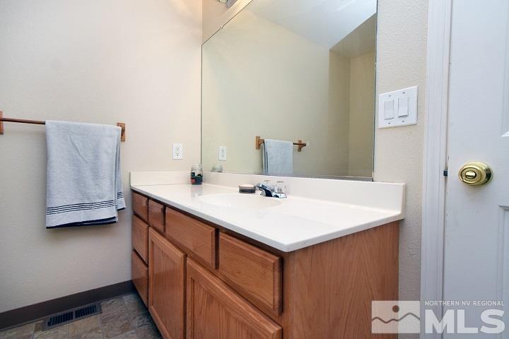 4755 Goodwin Road Sparks, NV 89436 - Photo 15 of 38 a bathroom with a sink and a mirror