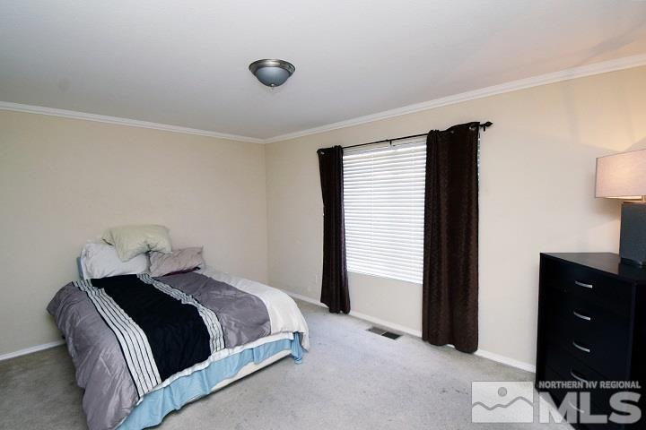 4755 Goodwin Road Sparks, NV 89436 - Photo 18 of 38 a bedroom with a bed and window