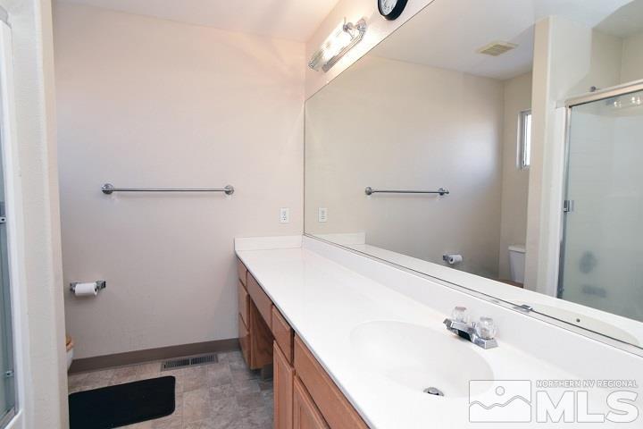 4755 Goodwin Road Sparks, NV 89436 - Photo 23 of 38 a bathroom with a tub sink and vanity