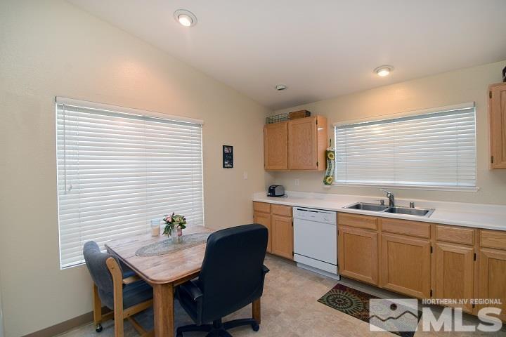 4755 Goodwin Road Sparks, NV 89436 - Photo 4 of 38 a kitchen with a table chairs sink and cabinets