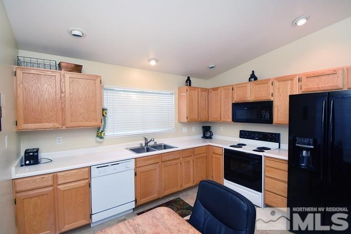 4755 Goodwin Road Sparks, NV 89436 - Photo 5 of 38 a kitchen with stainless steel appliances a sink dishwasher stove top oven and refrigerator