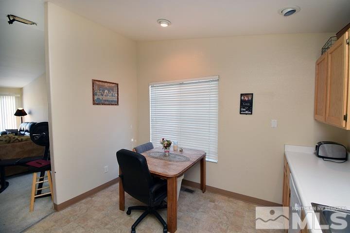 4755 Goodwin Road Sparks, NV 89436 - Photo 6 of 38 a view of a workspace with furniture and a couch
