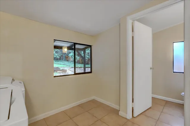 a backyard of a house with a large tree