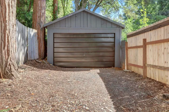 a view of a house with a yard patio and wooden deck