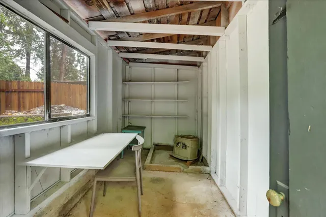 a front view of a house with garden and sitting area