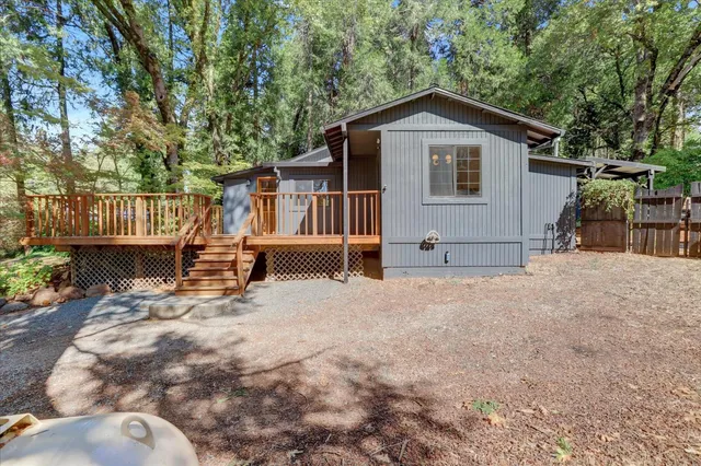 a view of a chair and table in backyard of the house