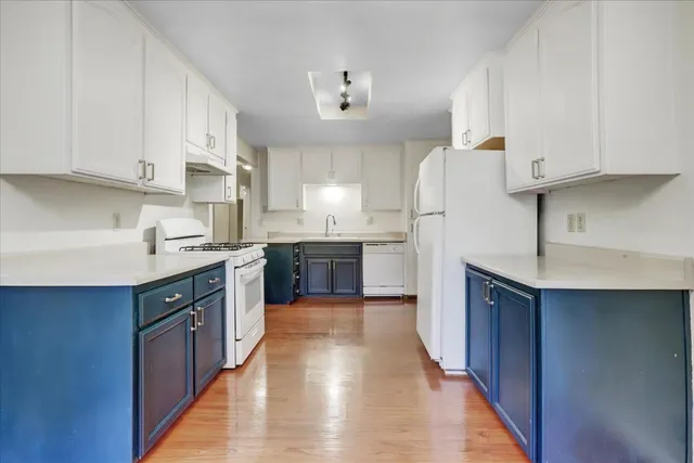 a kitchen with stainless steel appliances granite countertop a stove top oven and sink