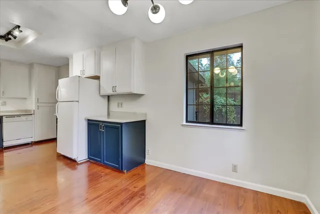 a view of a room with wooden floor and windows