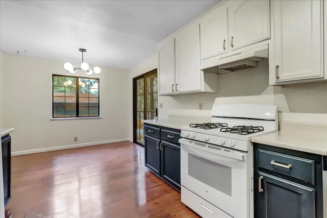 an empty room with a door and wooden floor