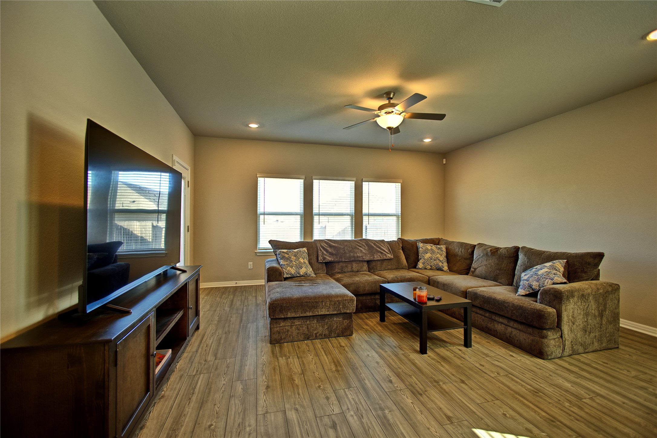 2809 Moyer Lane Round Rock, TX 78665 - Photo 5 of 22 Living room with ceiling fan, wood-type flooring, and recessed lighting