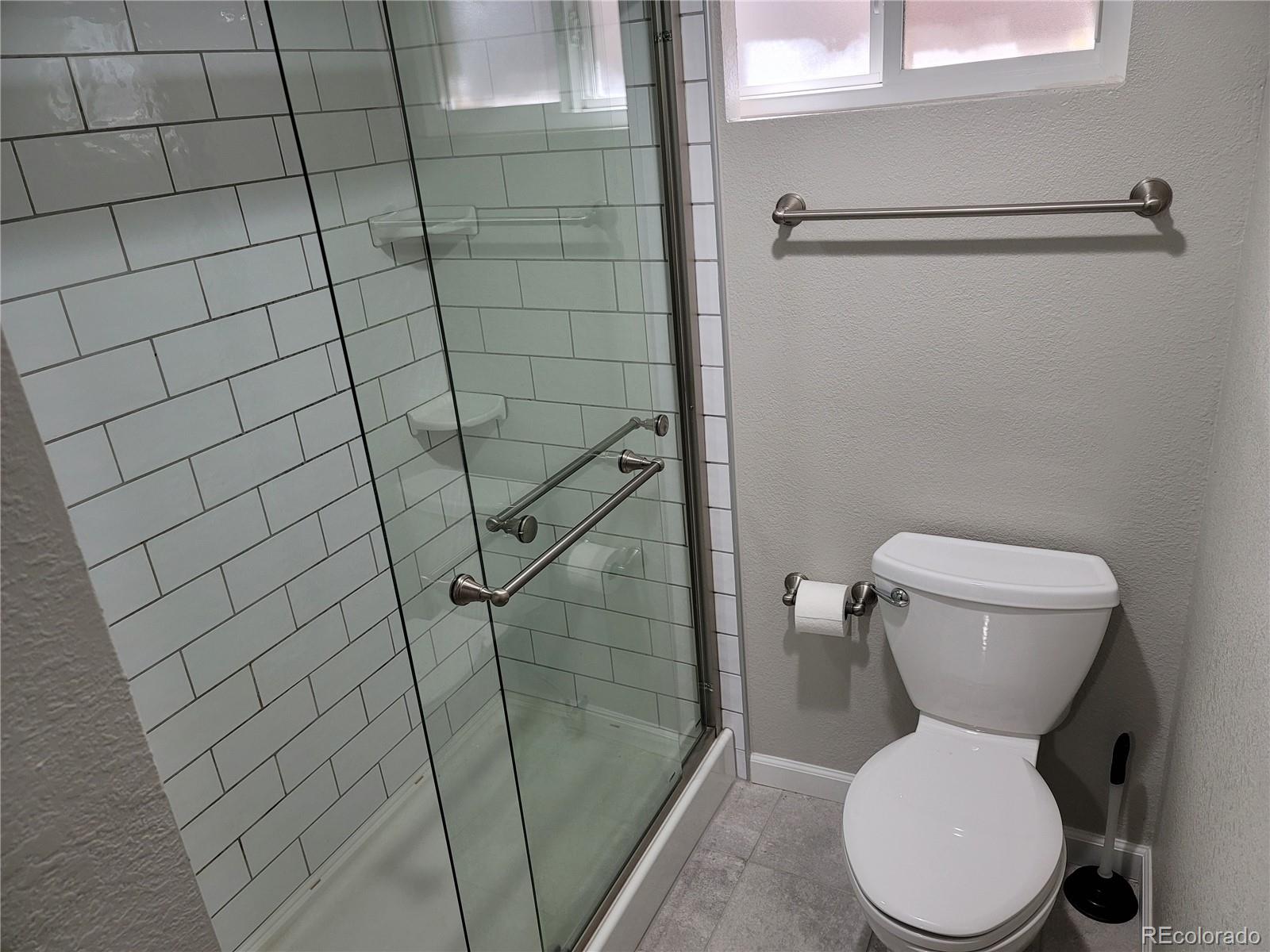 2834 Curtis Street, Unit 3 Denver, CO 80205 - Photo 19 of 22 a bathroom with a toilet and a shower