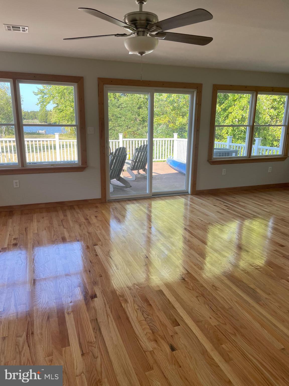 29 Dock Avenue Waretown, NJ 08758 - Photo 12 of 21 a view of empty room with wooden floor and fan