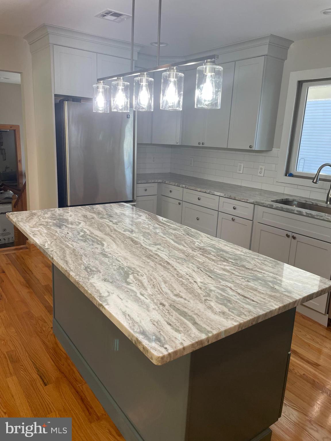 29 Dock Avenue Waretown, NJ 08758 - Photo 5 of 21 a close view of kitchen island a sink wooden floor kitchen island and chandelier