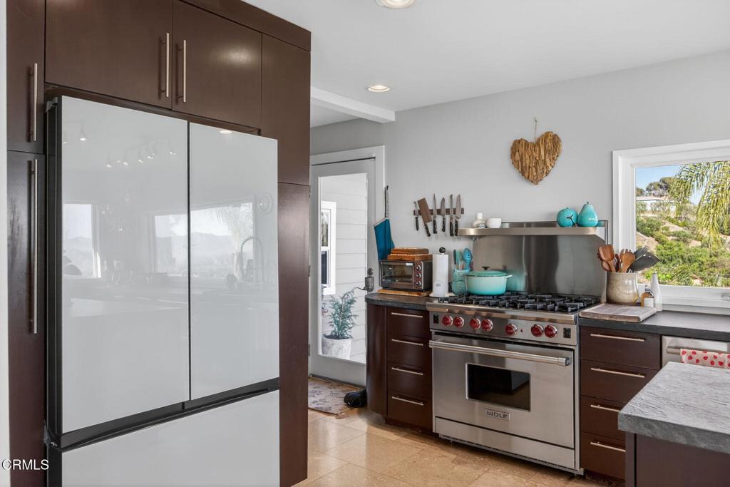 559 North Loop Drive Camarillo, CA 93010 - Photo 27 of 76 a kitchen with stainless steel appliances granite countertop a stove a refrigerator and a microwave