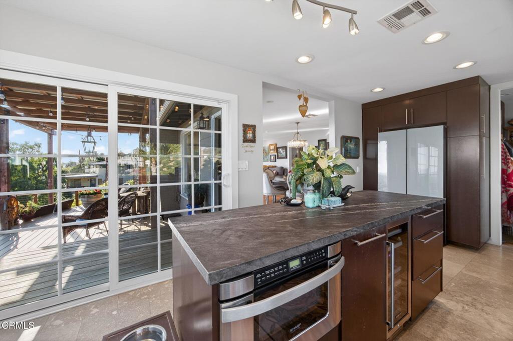 559 North Loop Drive Camarillo, CA 93010 - Photo 29 of 76 a view of a kitchen with kitchen island a counter top space a sink and appliances