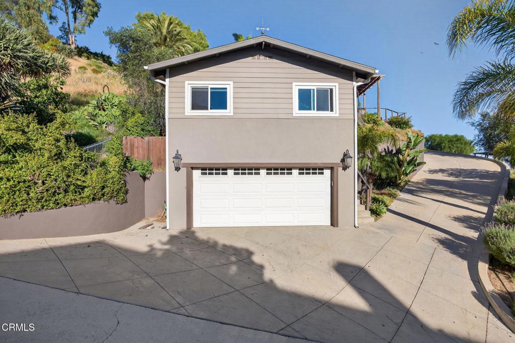 559 North Loop Drive Camarillo, CA 93010 - Photo 58 of 76 a front view of a house with a yard and garage