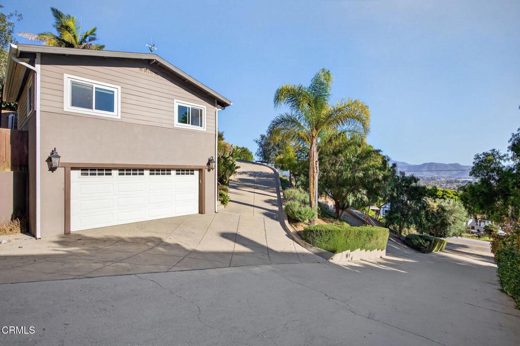 559 North Loop Drive Camarillo, CA 93010 - Photo 59 of 76 a front view of a house with a yard and a garage