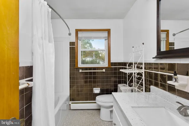 a white toilet sitting next to a bathroom sink