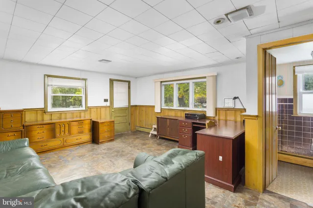 a bedroom with furniture and large windows