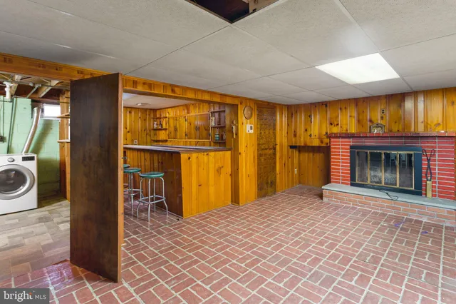 a view of an empty room with a fireplace and a window