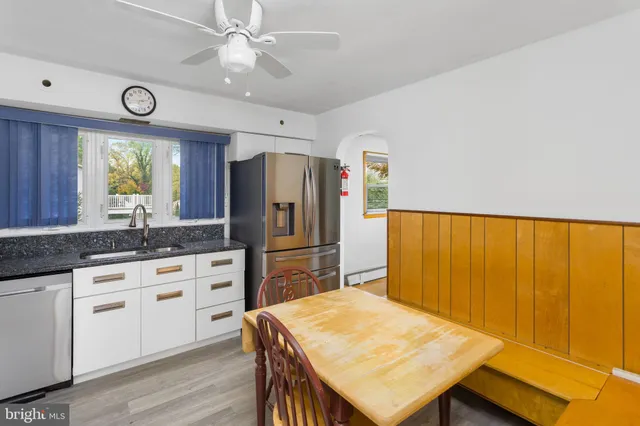 a kitchen with refrigerator cabinets and wooden floor