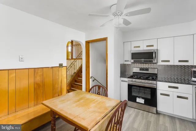a kitchen with a stove a sink and a refrigerator