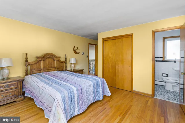 a bedroom with a bed and a view of bathroom