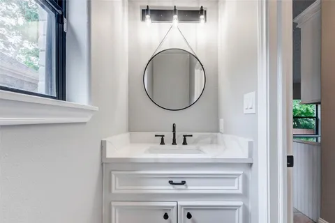 a bathroom with a double vanity sink a mirror and a shower