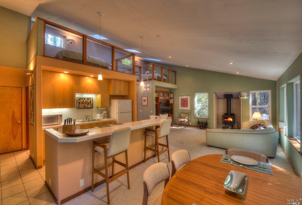 33097 Timber Ridge Road The Sea Ranch, CA 95497 - Photo 1 of 1 a dining room with stainless steel appliances kitchen island granite countertop a table and chairs