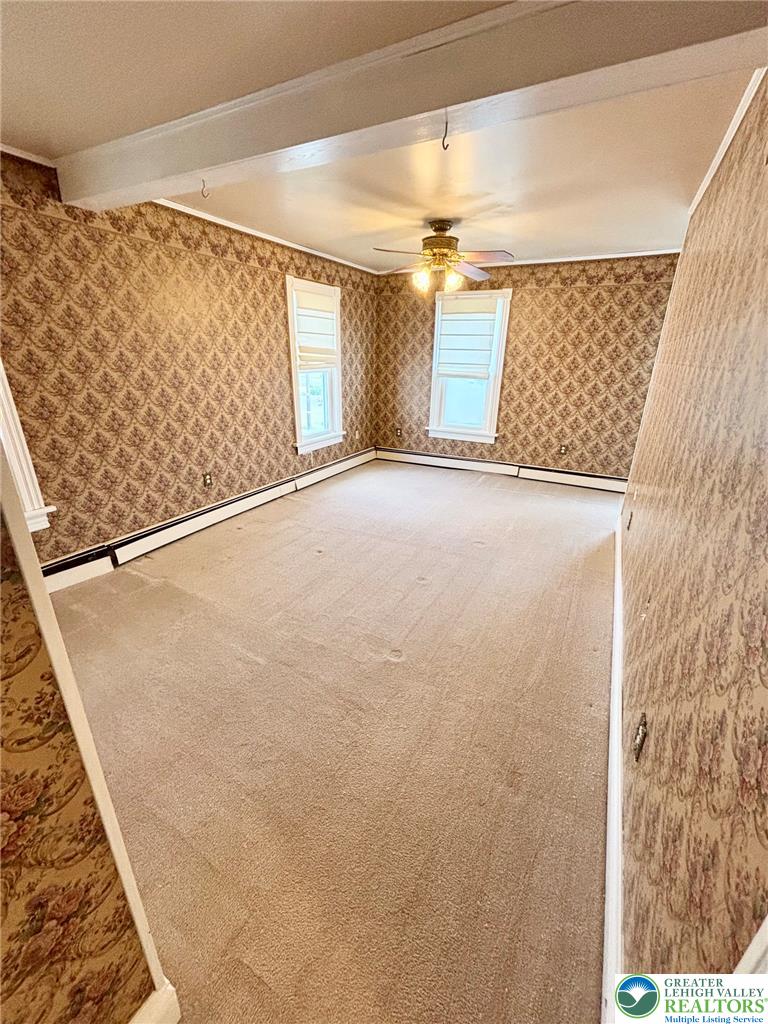7241 Decatur Street New Tripoli, PA 18066 - Photo 16 of 36 A quiet space awaits customization with neutral carpet and ample natural light.