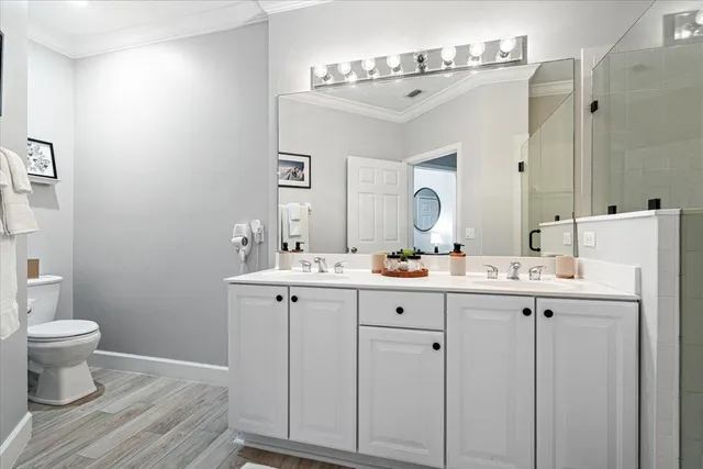 a view of a hallway with wooden floor and a livingroom