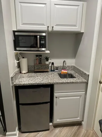 a kitchen with a refrigerator and cabinets