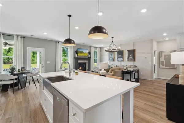 a large kitchen with kitchen island stainless steel appliances a stove center island and living room view