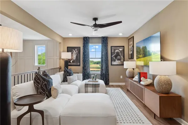 a bedroom with furniture and a large window