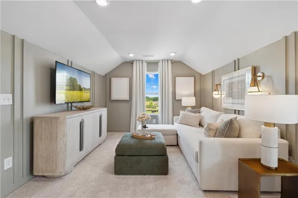 a bed sitting in a spacious bedroom next to a window