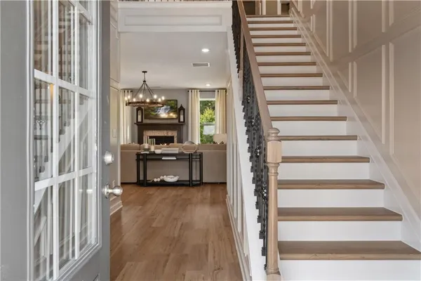 a view of a hallway with wooden floor and entryway