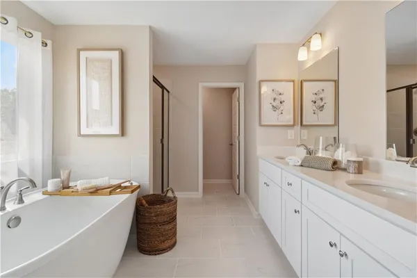 a bathroom with double vanity sinks a vanity and a large mirror