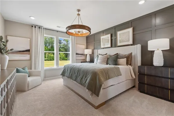 a spacious bedroom with a bed and a large window