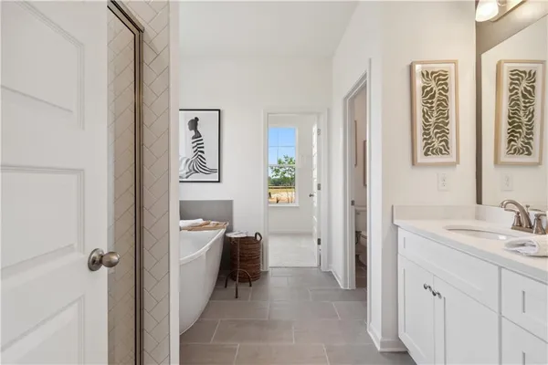 a spacious bathroom with a sink a mirror and a toilet