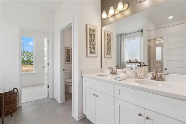 a bathroom with a double vanity sink and a mirror