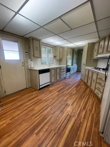 a view of a room with furniture wooden floor and window