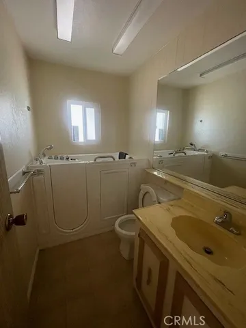 a bathroom with a sink a toilet and a mirror