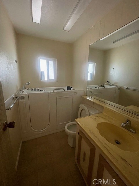 2230 Lake Park Drive, Unit 113 San Jacinto, CA 92583 - Photo 24 of 25 a bathroom with a sink a toilet and a mirror