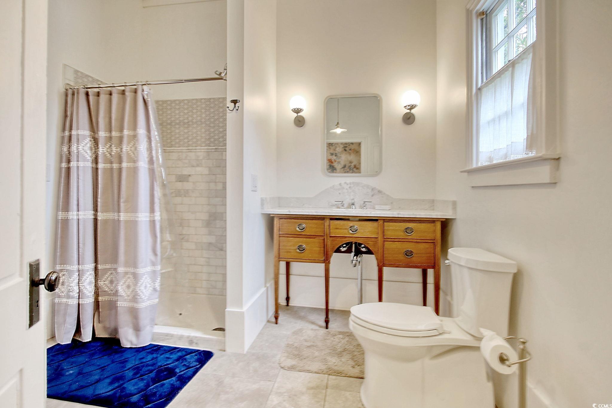 100 Northeast Ct Street Marion, SC 29571 - Photo 20 of 40 Bathroom with a shower stall, vanity, and light tile patterned floors