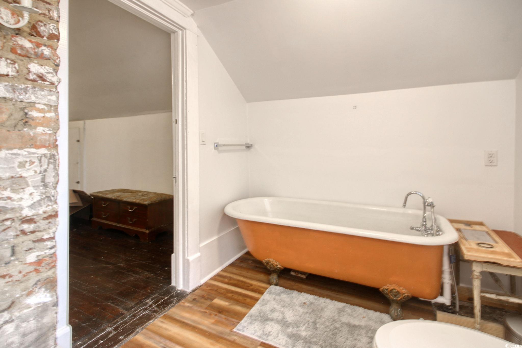 100 Northeast Ct Street Marion, SC 29571 - Photo 28 of 40 Bathroom with a freestanding tub, lofted ceiling, and wood finished floors