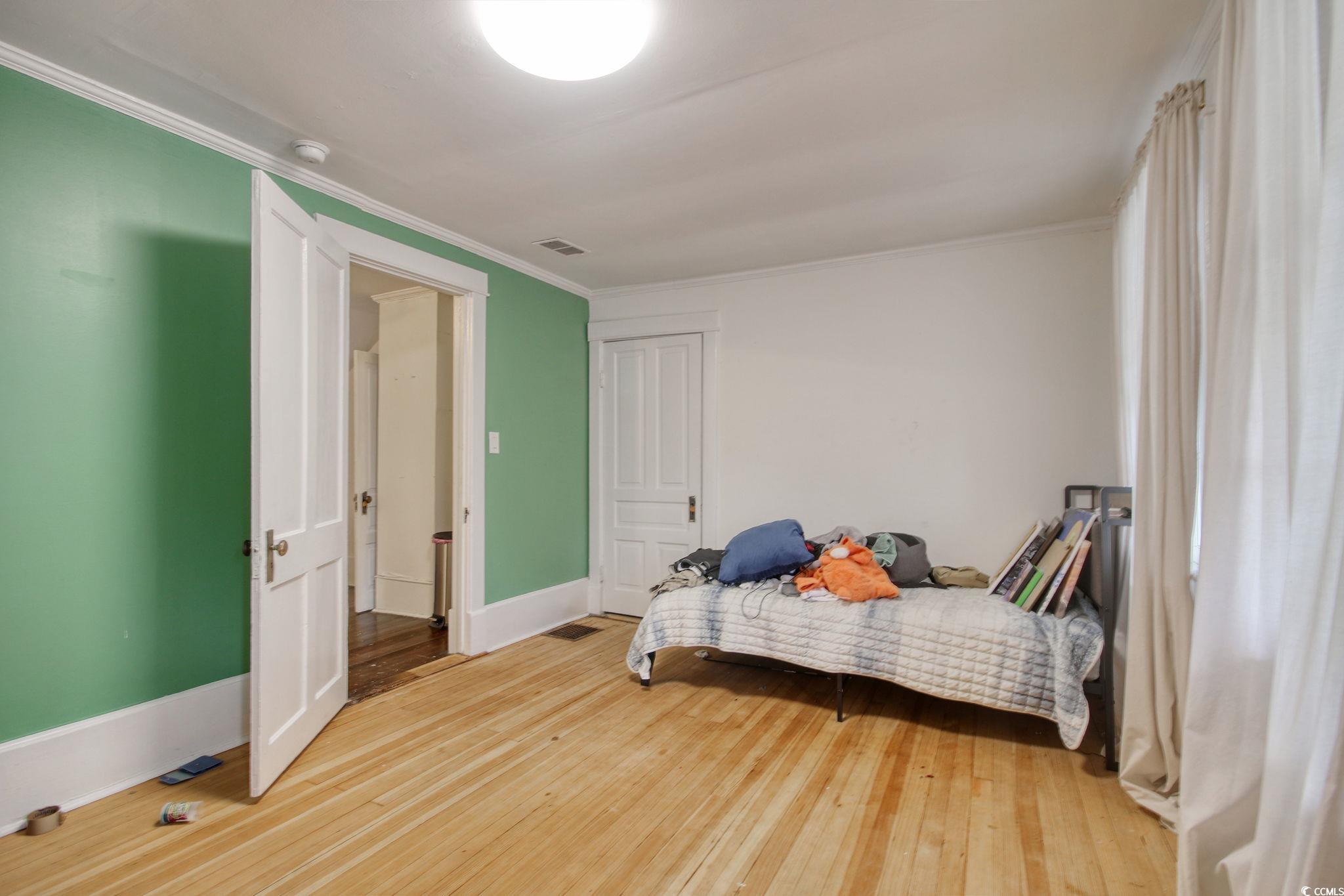 100 Northeast Ct Street Marion, SC 29571 - Photo 30 of 40 Bedroom with light wood-type flooring and ornamental molding