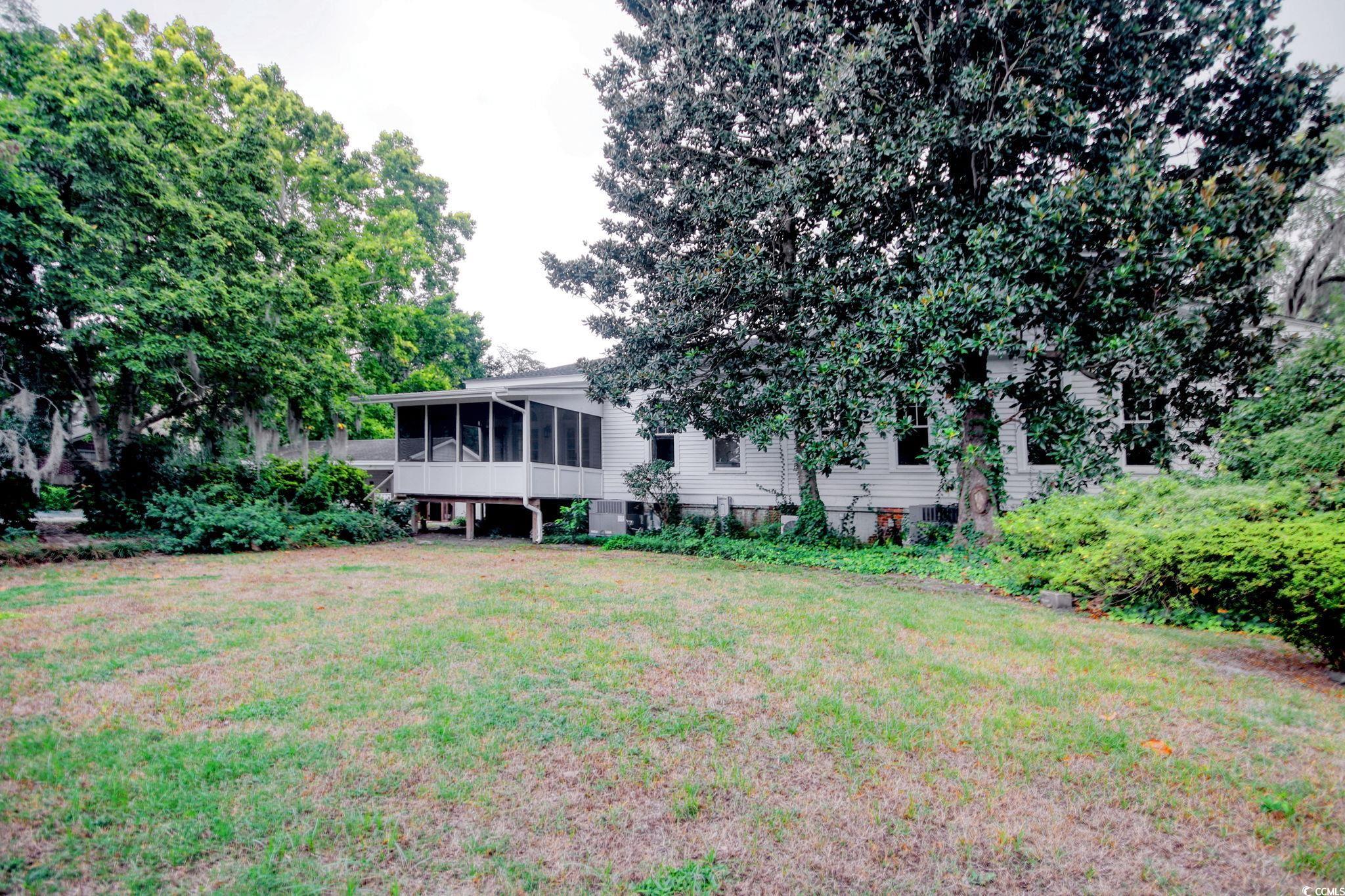 100 Northeast Ct Street Marion, SC 29571 - Photo 35 of 40 Rear view of property featuring a sunroom and a lawn