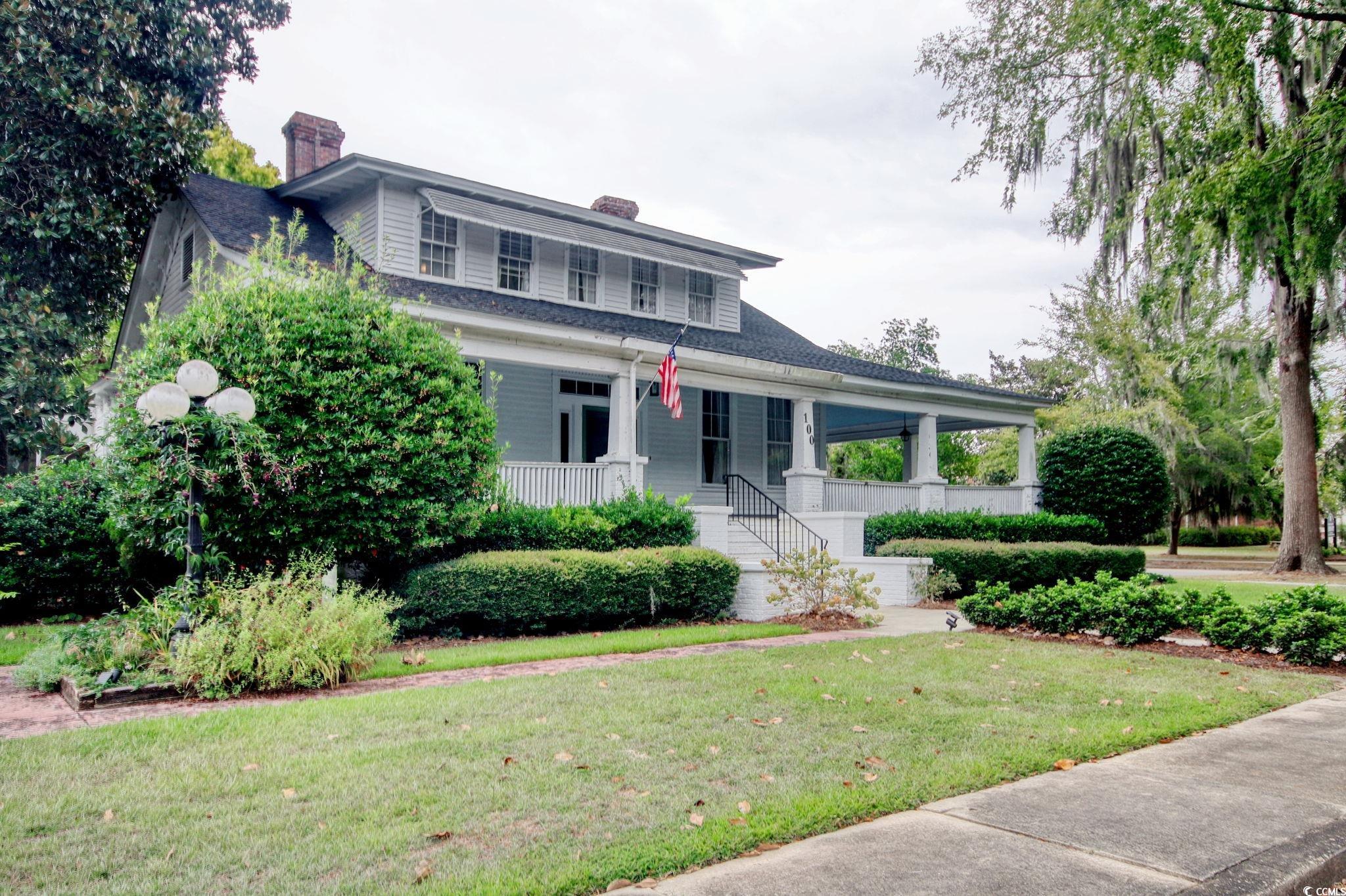 100 Northeast Ct Street Marion, SC 29571 - Photo 4 of 40 View of front of house with a chimney, a porch, a shingled roof, and a front yard