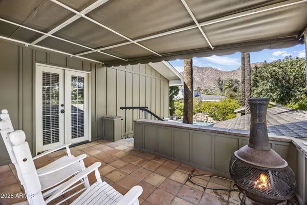 a view of a house with backyard porch and sitting area