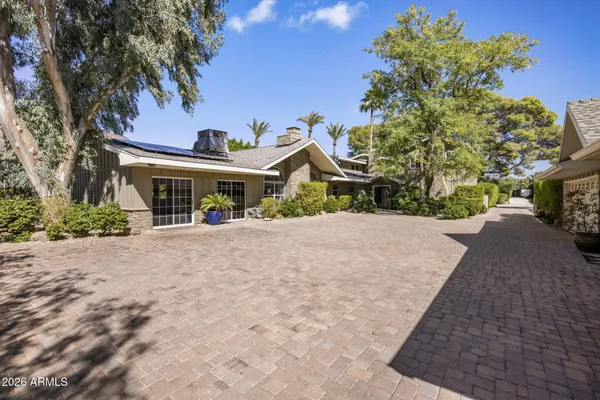 a view of a hallway with wooden floor and a livingroom view